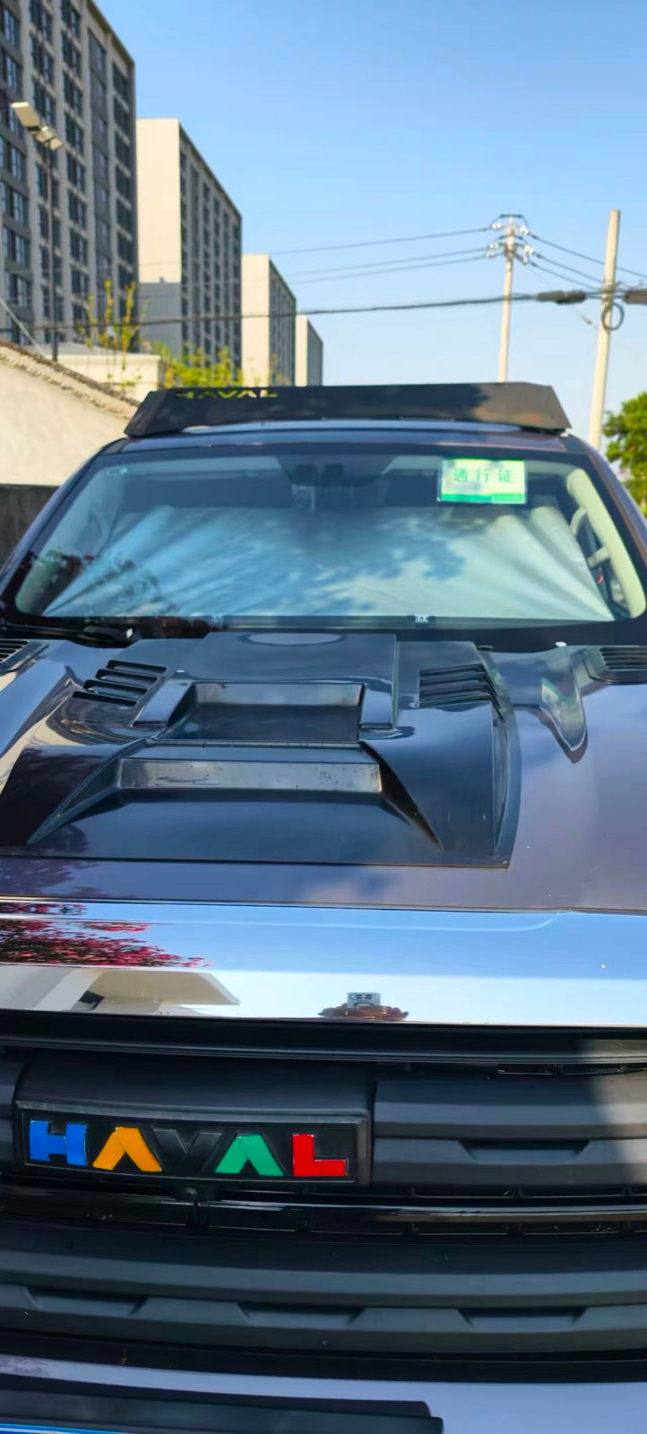 Car parked in sun with the silver shade filling the windshield