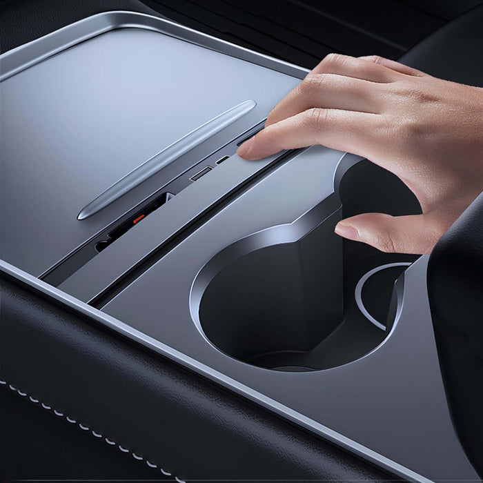Hand pressing the retract button on the PowerDock, flush with the console