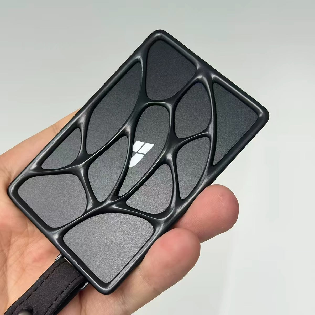 Apex sculpted metal NFC key card holder held in hand, Black